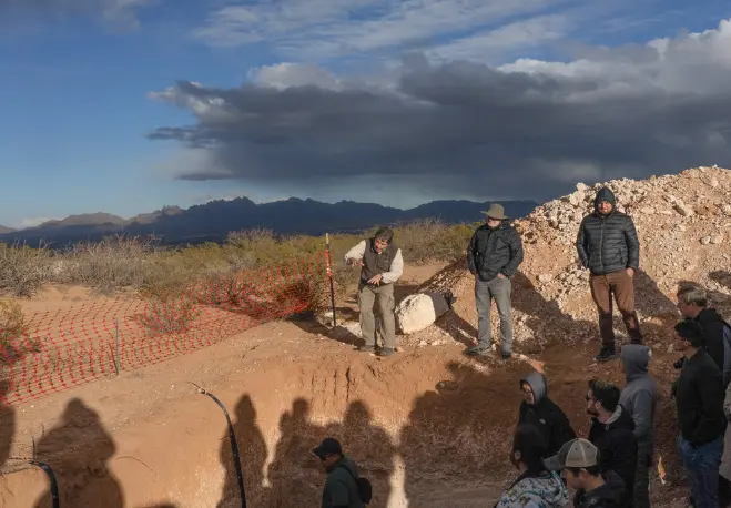 "Curtis Monger from New Mexico State University explains the relation between desert geomorphology and soil development. Photo by Christine Stockwell. "